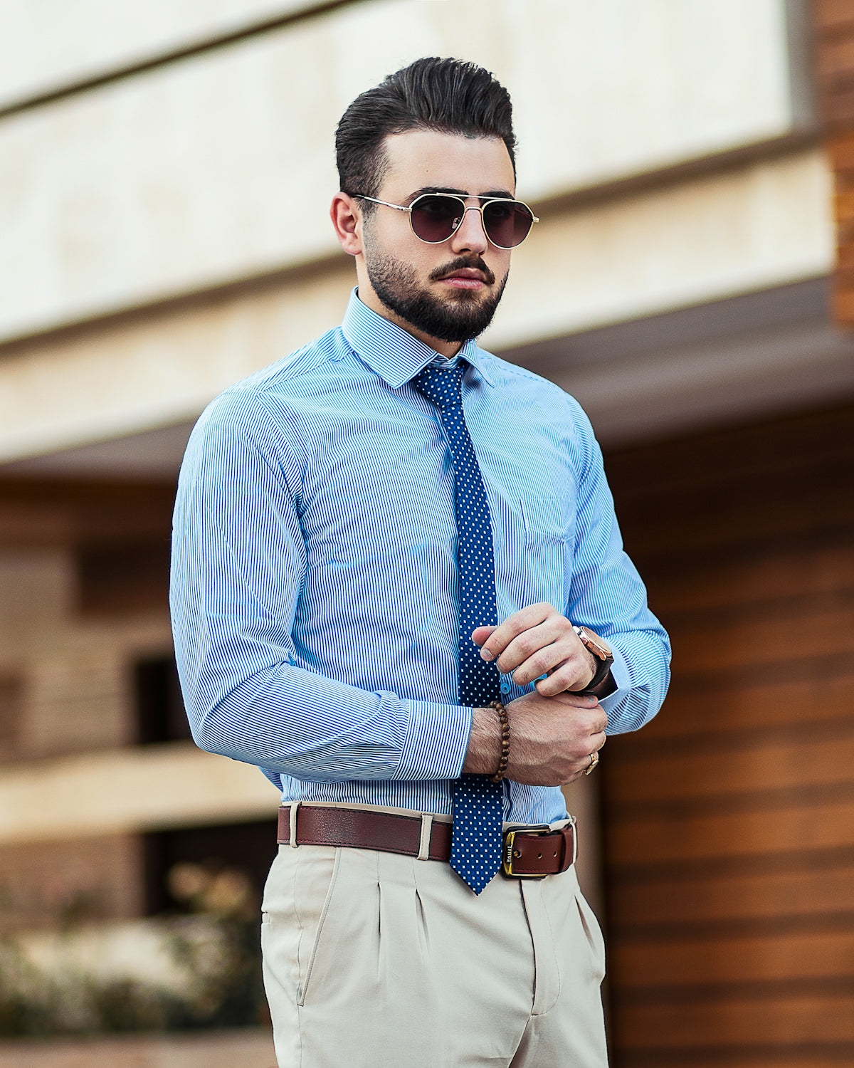 man in blue dress shirt wearing black sunglasses