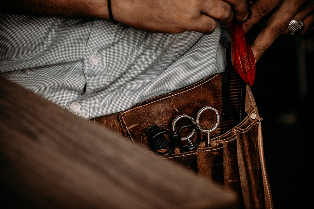 a man cutting a belt