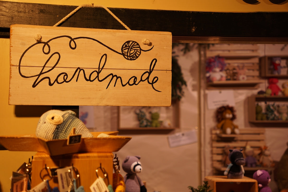 Wooden sign with handmade written on it.