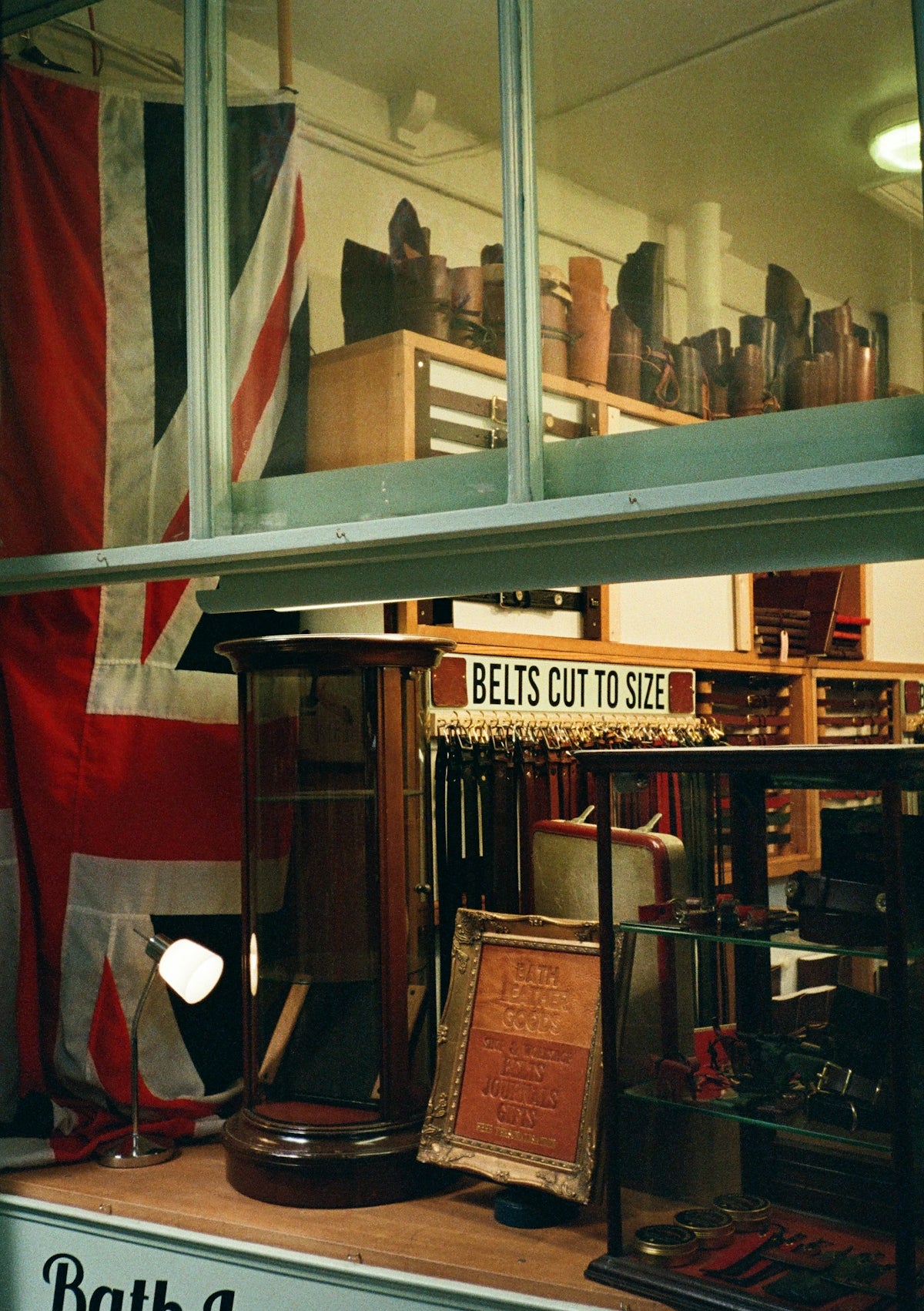 Belts displayed in a shop with union jack flag.